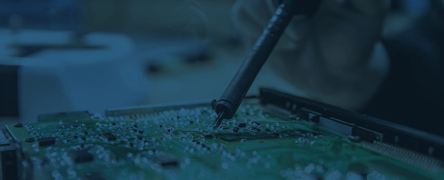 Person hand soldering a printed circuit board